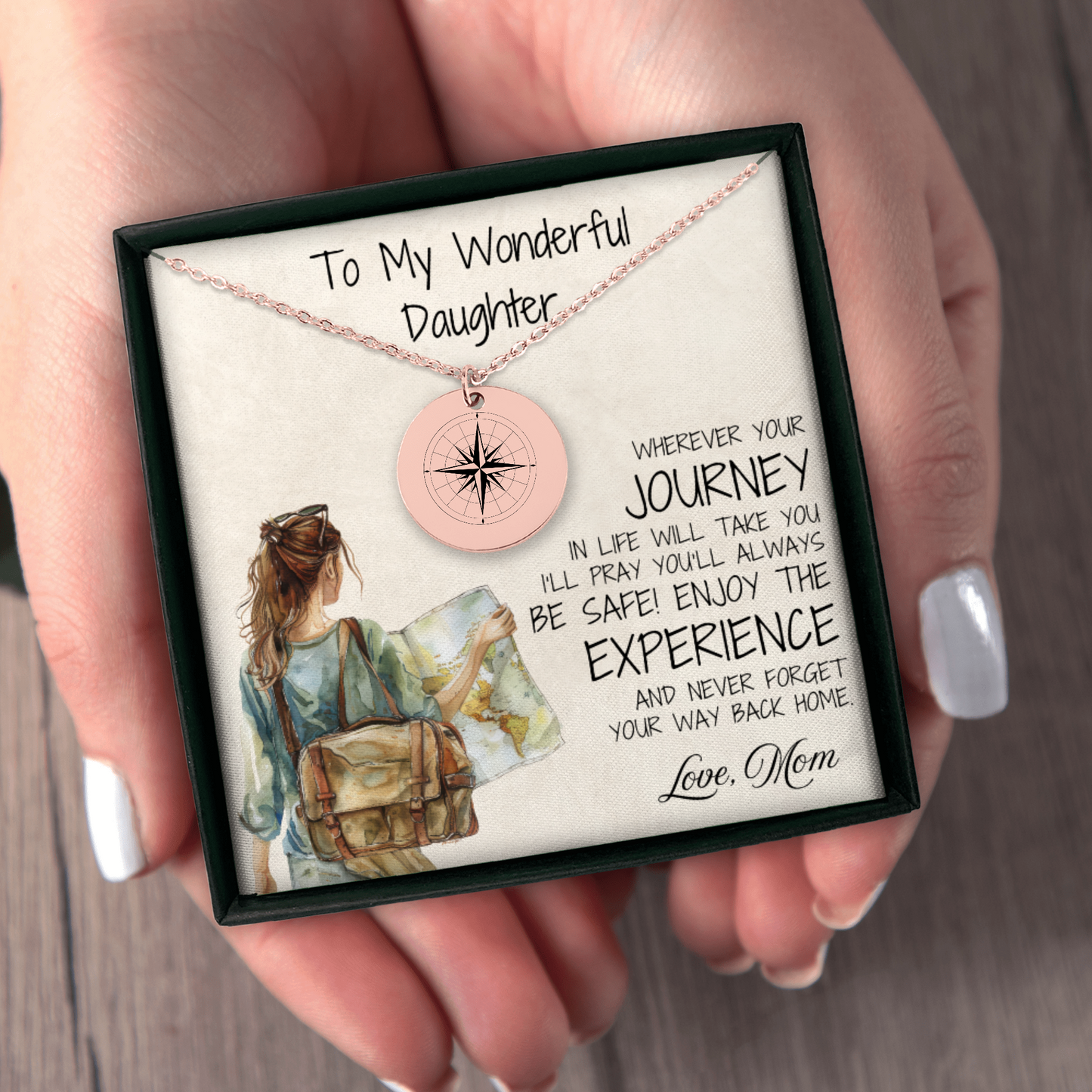 A rose gold compass necklace, engraved with love, perfect for your daughter. This thoughtful gift is ideal for graduations, long-distance connections, or just to remind her that "Adventure Awaits" in every step of her journey.